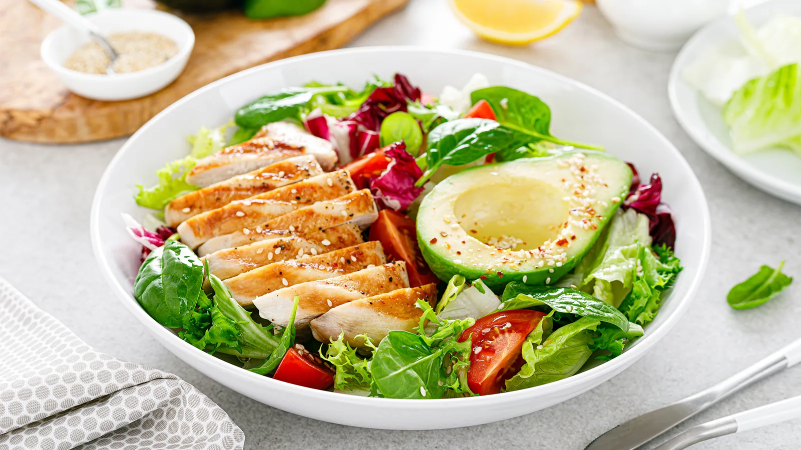 Prepared salad bowl with chicken and avocado