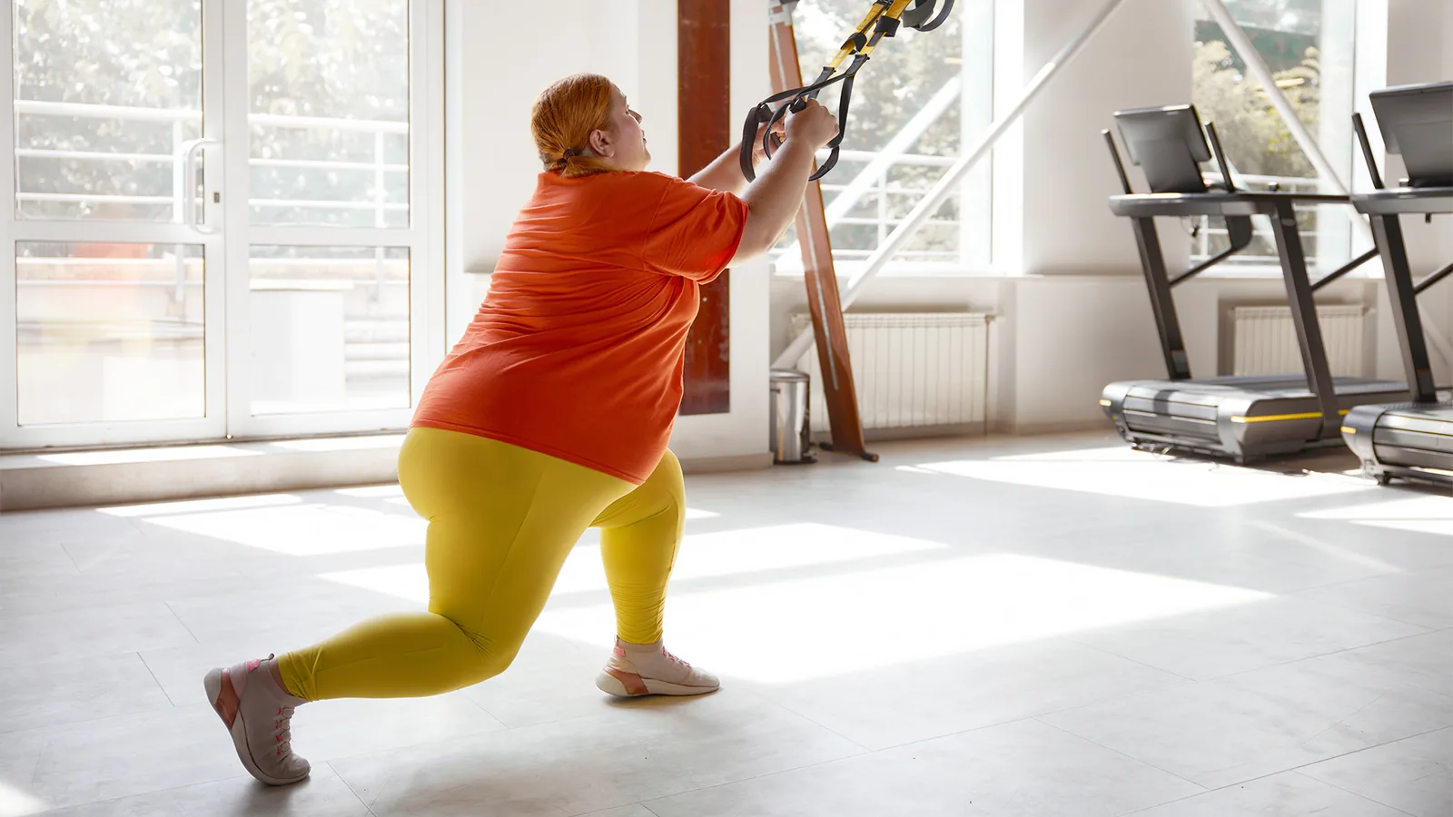 Person exercising with a cable machine in a gym