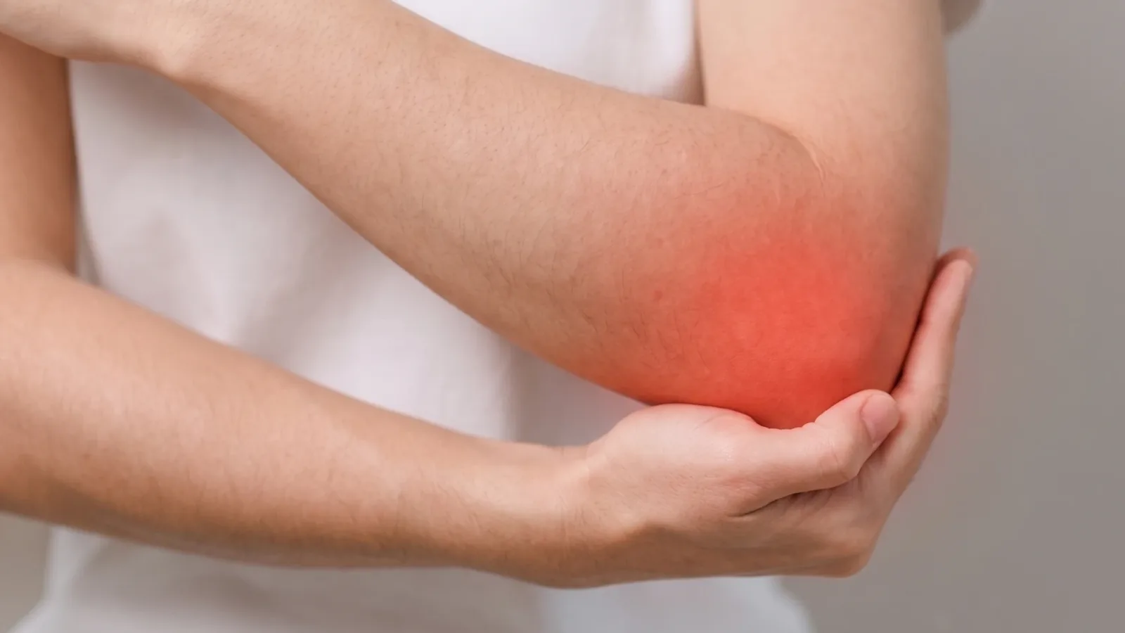 Elbow held in the other hand with the sore point marked in red