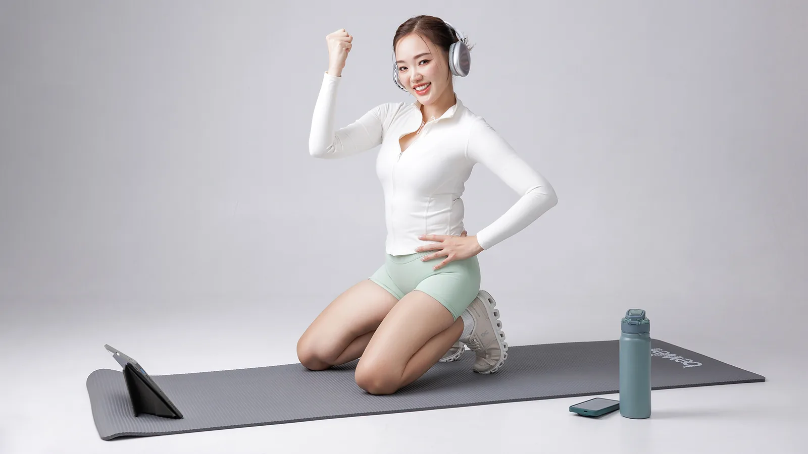 Woman kneeling on an exercise mat